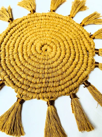This angled close-up highlights the craftsmanship of the knots and the texture of the tassels. It shows how the piece adds a three-dimensional, tactile quality to your decor.