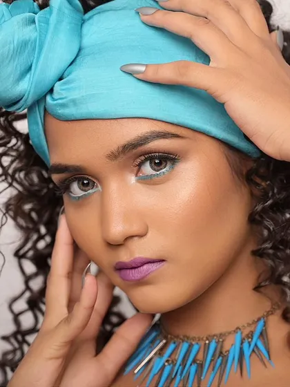 A close-up on the face, highlighting the white graphic liner in the inner corner of the eye.