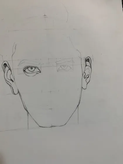 A student practices the basic construction of a face, an essential step before adding details and shading in our charcoal portraiture course.
