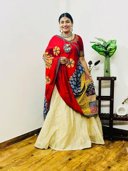 Another look at my Navratri outfit. The combination of red, cream, and indigo with traditional prints creates a vibrant and celebratory feel.