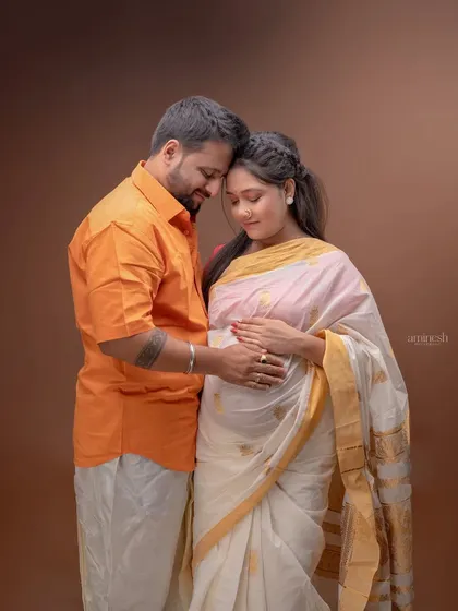 A tender moment from a traditional Maharashtrian maternity shoot. The couple is dressed in cultural attire, creating a portrait that is both personal and deeply rooted in heritage.
