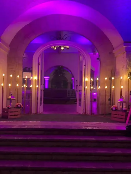 Here is another view of an event entrance, this time lit with a vibrant purple hue. This shows how we use lighting to completely change the mood and match the theme of your party.