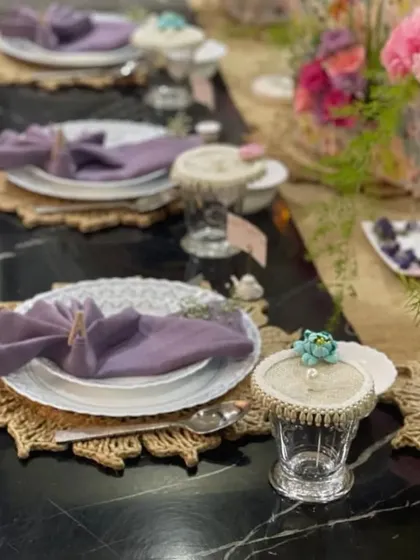 This is a complete tablescape I designed, showing how different elements come together. You can see my custom embellished glass covers, which protect drinks while adding a touch of glamour, alongside coordinated napkins and natural jute placemats.