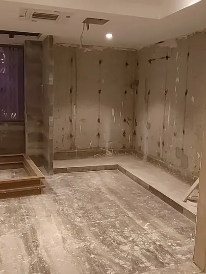 This image shows a room after the initial plastering and waterproofing, preparing the walls for the final finishes. This foundational work is essential for a high-quality, long-lasting interior.