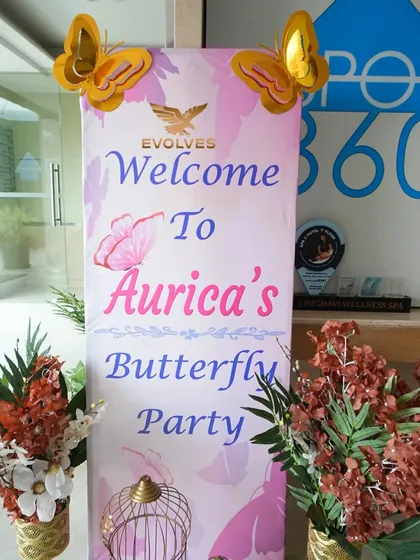 The welcome banner for Aurica's butterfly-themed party. A personalized entrance is the first step in creating a cohesive and memorable event experience for guests.