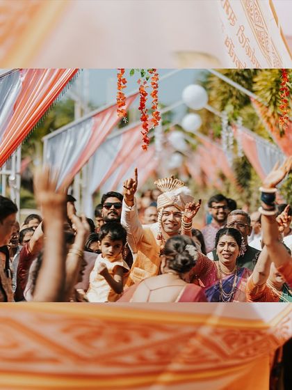 The groom's grand entrance! This photo captures the energy and excitement of the baraat, with the groom celebrating surrounded by his family and friends.