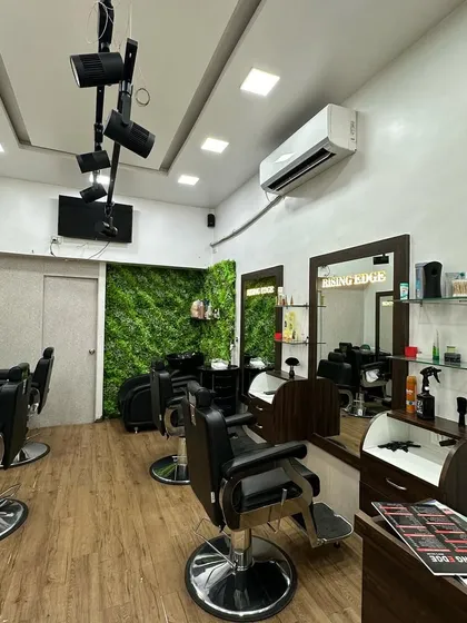 An overview of the salon interior, showcasing the track lighting and clean, wooden flooring. It's a professional environment where you can expect top-quality service.