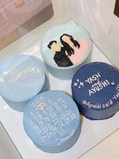 Celebrating love and milestones with this sweet set of four personalized bento cakes for an engagement, including a calendar marking the special date.