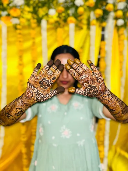 A playful pose showing off the back of the hands, which feature the groom's name and initial.