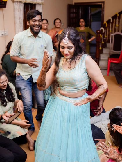 Dancing with joy at her Mehendi. The makeup is light and comfortable, perfect for a day filled with fun, laughter, and dancing.