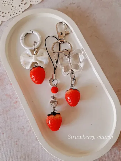 Inspired by the Ghibli trend, this image showcases my strawberry charm collection. You can get them on a bag charm, keychain, or phone strap for a touch of whimsy.