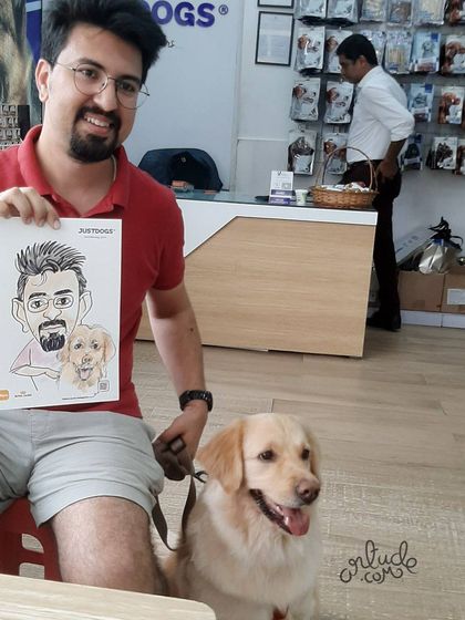 A happy customer and his dog posing with their custom caricature at the JUSTDOGS event.