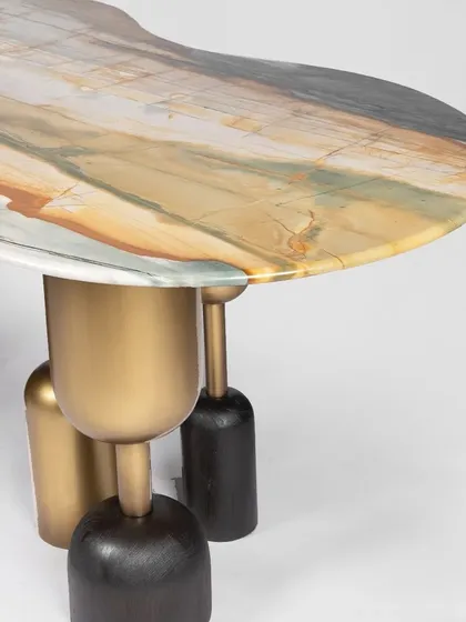 I believe God is in the details, and this dining table is a testament to that philosophy. The top is a single, stunning piece of Lotus Quartz, with its natural, painterly strokes of color. I paired it with a sculptural base of solid teak wood and antique-finished brass, creating a functional centerpiece that is pure art.