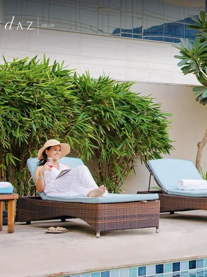 Find your perfect spot to unwind by the pool at Andaz Delhi. Here, you can soak up the sun with a good book and a refreshing drink in a chic, relaxing environment.