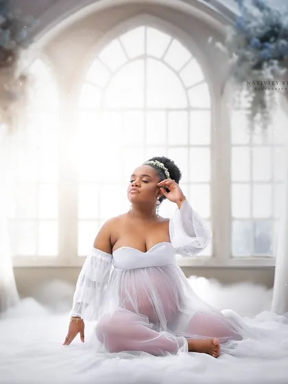 A dreamy, heaven-like setup with clouds and ethereal light. This fine art portrait in a white gown is truly magical.