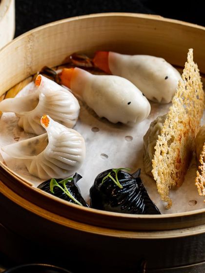 Unlock a treasure trove of gastronomic delight with our extraordinary dim sum platter. This bamboo steamer holds a curated selection of our finest dumplings, including swan and black cod.