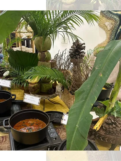Another angle of our tropical buffet, showing how we integrate natural elements like banana leaves and coconuts into our presentation.