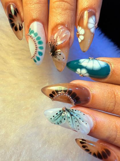 A full view of one of our most artistic and creative nail sets. Each nail tells its own story with a unique combination of colors, patterns, and 3D elements.