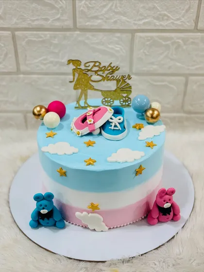 Welcoming a new arrival with a classic baby shower cake. This design uses soft pink and blue tones, with adorable fondant baby shoes and teddy bears to celebrate the parents-to-be.