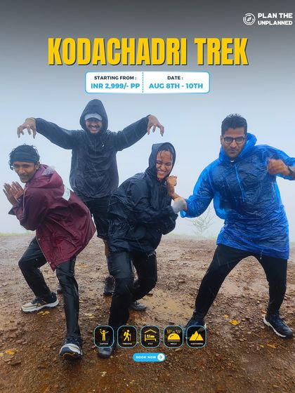 Four trekkers having fun in their raincoats on the misty Kodachadri trail.