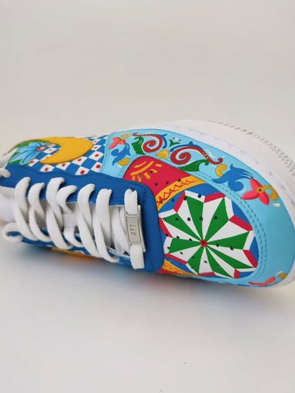 A top-down view of the maximalist Indian art sneakers. The design on the toe box is different for each shoe, one featuring a floral pattern and the other a geometric star, making them a true one-of-one pair.