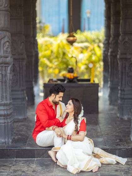 A beautiful moment between a couple during their pre-wedding shoot. The traditional setting and outfits create a truly magical atmosphere.