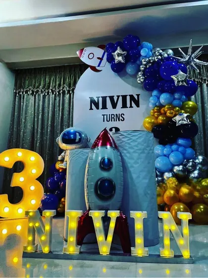 A close-up of the personalized elements in the Space theme decor, including the birthday boy's name in lights.
