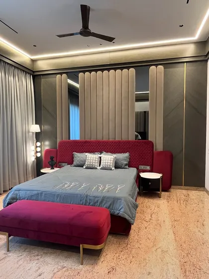 For this master bedroom in Ambala, we used a bold maroon and rich textures to create a space that feels both opulent and deeply personal. The custom upholstered wall panel behind the bed adds a layer of softness and grandeur.