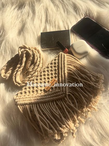 Another look at the beige macrame sling bag, showing off the beautiful fringe and the texture of the knots.