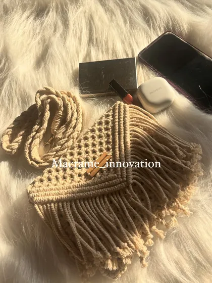 Another look at the beige macrame sling bag, showing off the beautiful fringe and the texture of the knots.
