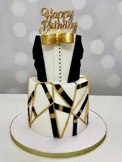I also create sleek and sophisticated designs for men. This two-tier tuxedo cake with abstract gold details is perfect for a milestone birthday, combining chocolate truffle and coffee chocolate flavors.