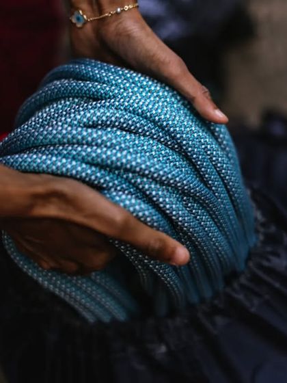 Coiling the rope at the end of the day. We teach proper rope care to extend the life of our equipment.