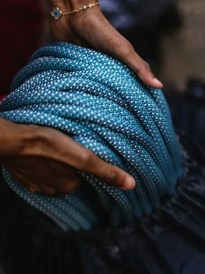 Coiling the rope at the end of the day. We teach proper rope care to extend the life of our equipment.