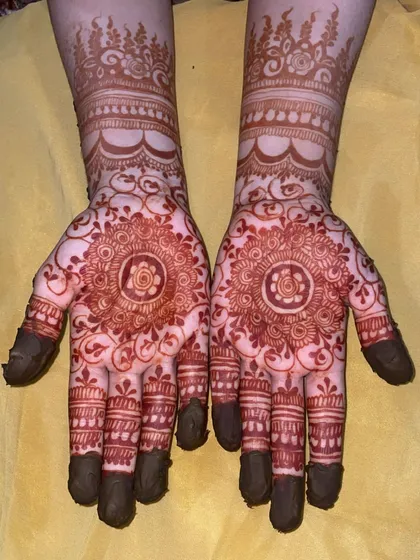 A beautiful example of a traditional mandala design. The stain is a rich, dark brown, and the details are still sharp, showing the quality of the henna paste.