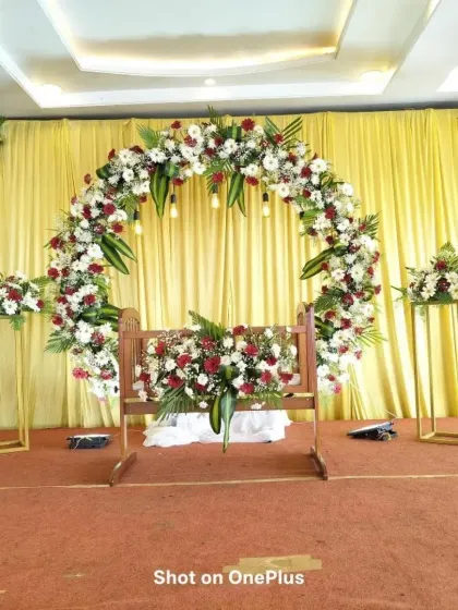 Here is a classic naming ceremony stage with a full floral ring of red and white gerberas. The decorated cradle sits perfectly in the center, ready for the baby's introduction ceremony.