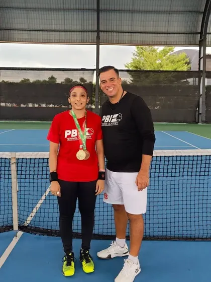 Our national deaf-tennis champion posing with her coach after a successful tournament. We are proud to offer specialized coaching for athletes with diverse abilities, helping each one reach their highest potential.