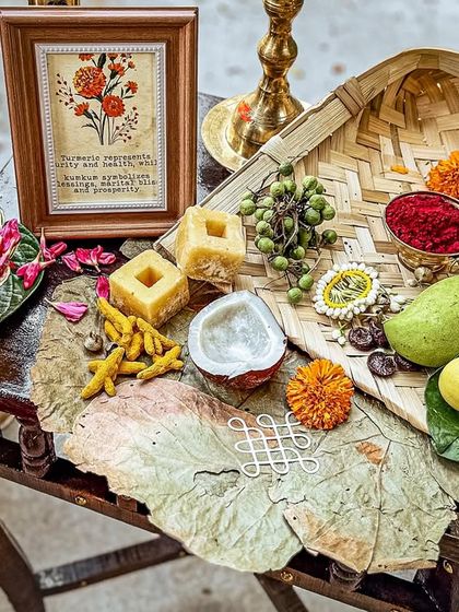 A charming corner with traditional offerings like coconut, mango, and turmeric, beautifully arranged on a vintage table.