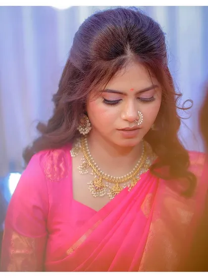 Soft pink hues for Ashlesha's engagement puja. The look is gentle, traditional, and perfectly suited for the ceremony.