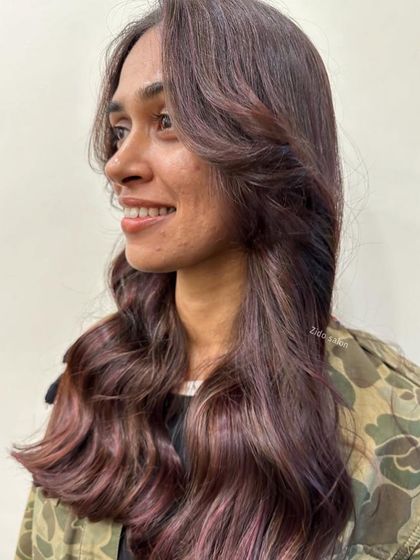 We call this look 'wine on brown'. We wove subtle crimson and wine-colored lowlights through a brunette base for a hint of color that adds richness and depth without being overpowering.