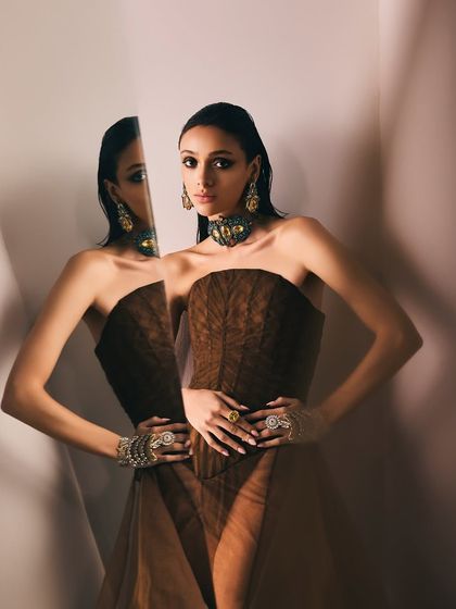 A striking image using a mirror to create a double-vision effect for the Reasons Jewellery campaign, showcasing the full jewelry set.