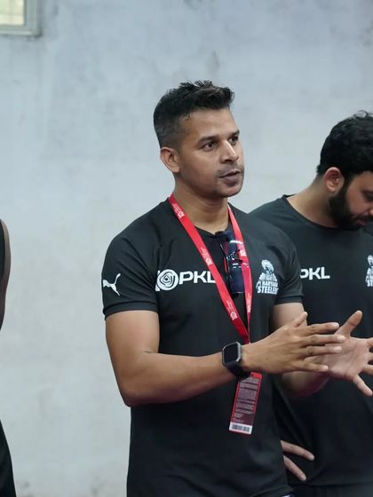 In conversation with one of the players, ensuring he understands his role and the expectations.