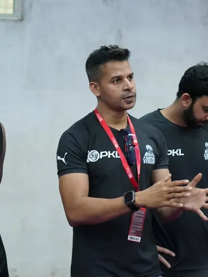 In conversation with one of the players, ensuring he understands his role and the expectations.