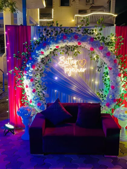 A straight-on view of the beautiful floral arch and seating area.