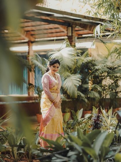 Vaishnavi amidst lush greenery, her pastel saree looking fresh and beautiful.