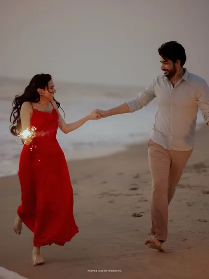 A joyful run along the beach with sparklers in hand. This pre-wedding shoot was about capturing the couple's carefree spirit and the magic of twilight by the sea.