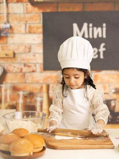 This little chef is hard at work in her mini kitchen, rolling out dough and surrounded by bread and pasta. These sessions are a recipe for adorable photos.