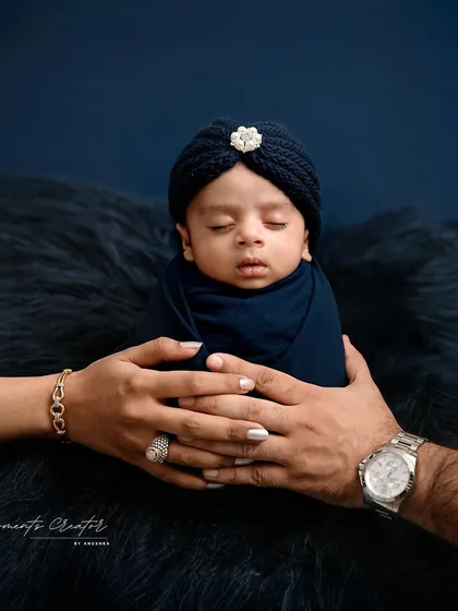 A tiny prince held safely in his parents' hands. This iconic newborn portrait captures the overwhelming love and protection that surrounds a new baby. It's a simple, powerful image that families will treasure forever.