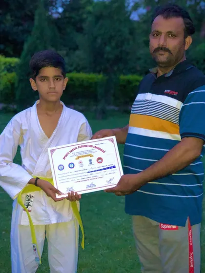 This student has earned his yellow belt. The first promotion is always a special one, marking the start of a long journey.