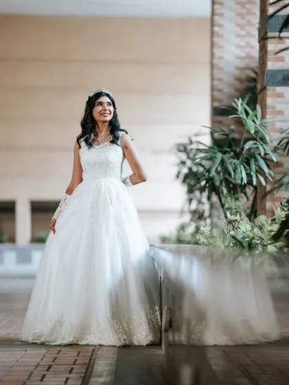 A full-length view of our bride's graceful look. The makeup is designed to look stunning from a distance, enhancing her features without being overpowering.