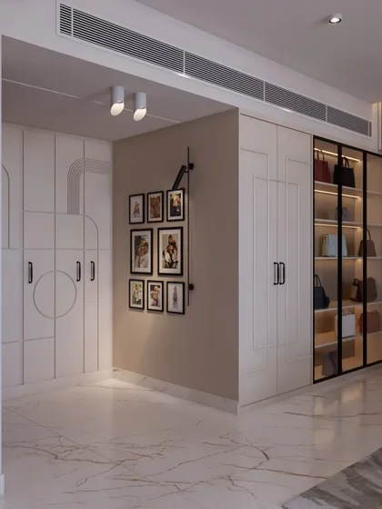 The wardrobe area features a mix of closed and open storage, with a dedicated gallery wall for personal photos, making the space feel truly unique to the homeowners.